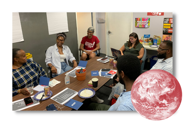 A group of Citizen Action members sitting around a conference table chatting.